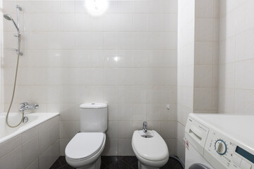 modern bathroom room with toilet and washing machine