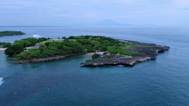 Aerial view of Rocky Islet With Surrounding Shallow Water , Jagged Basalt Edge And Green,Nusa Dua, Bali,Indonesia
