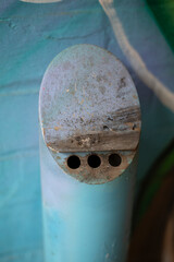 Wall mounted cylinder cigarette ash bin located in a small alley