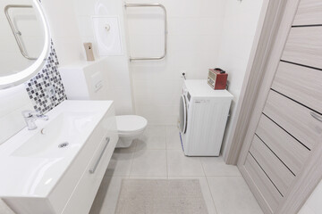 modern bathroom room with toilet and washing machine
