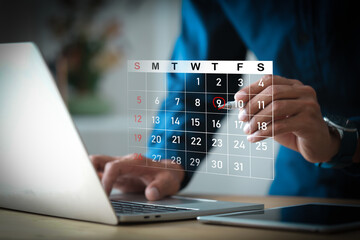 Businessman hands using laptop computer with virtual calendar interface for appointment scheduling.