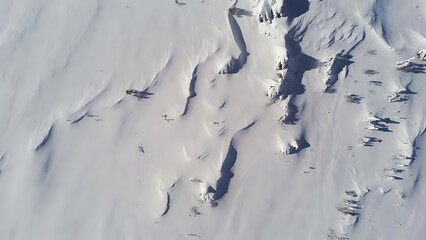 Abstract aerial view of a pristine snowy landscape with deep shadows