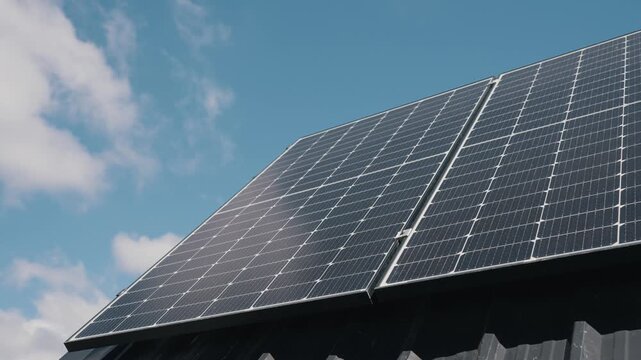Modern solar panels on the roof of a solar power plant capturing sunlight to generate clean energy, renewable power, and green electricity using advanced eco-friendly technology under blue sky
