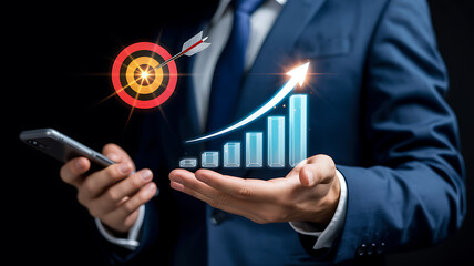 Businessman holding smartphone with growth chart and target with arrow business growth