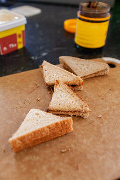 Vegemite sandwich triangles on cutting board on kitchen bench in Australia ready for morning tea