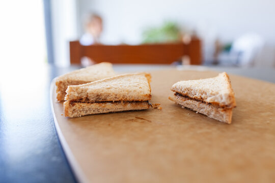 Vegemite sandwich triangles on cutting board on kitchen bench in Australia ready for morning tea