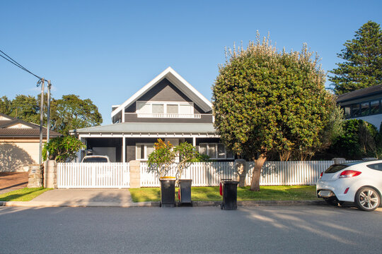 rubbish day, bins on the road in front of a 2 storey home in Sydney