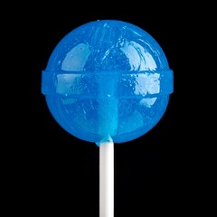 Blue lollipop on white stick. Opaque and shiny. Shot against a black background. Sweet treat, childhood favorite