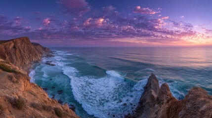 Coastal cliffs meet turquoise waves under a vibrant purple and orange sky at dawn or dusk, creating a serene and awe-inspiring landscape