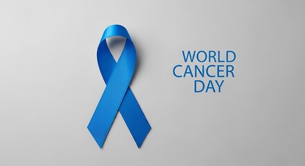 World Cancer Day awareness ribbon on gray background, a symbol of hope.