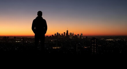 Fototapeta premium Solitary figure watches urban skyline illuminate during twilight transition