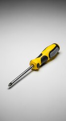 Yellow and Black Screwdriver on a White Surface.