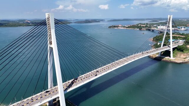 B roll of the Barelang Bridge in Batam showcasing its iconic cable bridge structure spanning blue waters with scenic island views and smooth urban connection