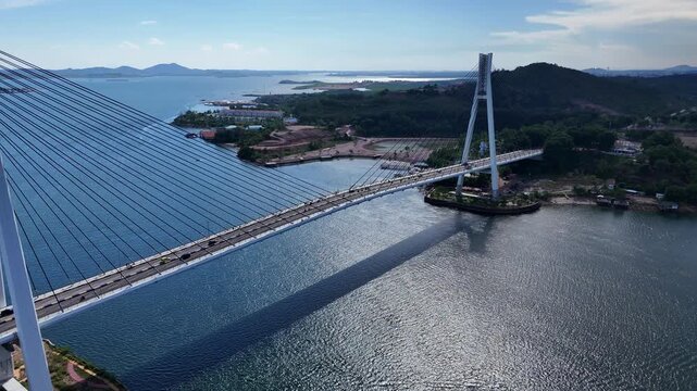 B roll of the Barelang Bridge in Batam showcasing its iconic cable bridge structure spanning blue waters with scenic island views and smooth urban connection