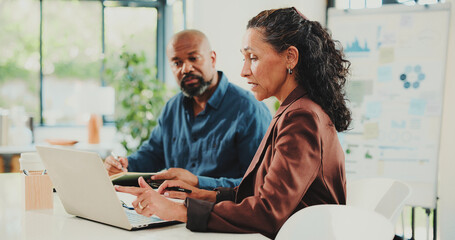 Finance, discussion or people in office with laptop, partnership or brainstorming for revenue growth. Collaboration, mature or sales analyst with tech, budget plan or feedback in performance analysis