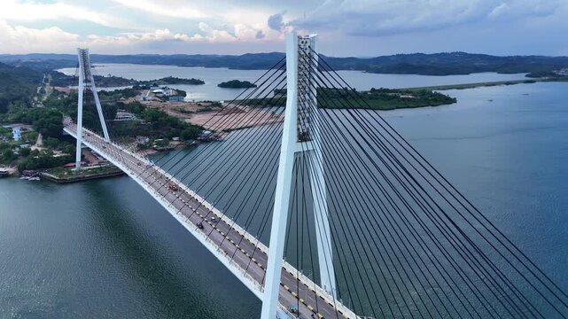 B roll of the Barelang Bridge in Batam showcasing its iconic cable bridge structure spanning blue waters with scenic island views and smooth urban connection