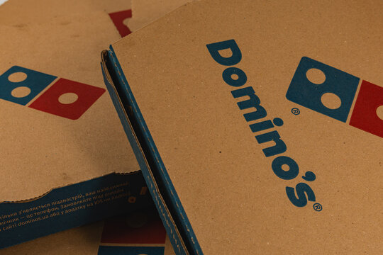 Lviv Ukraine 12.08.2025 Three delivery boxes are open on a table. They are from a popular pizza restaurant. The boxes have logos and are made of brown cardboard.