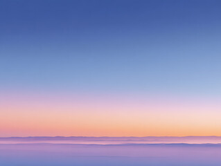 Fototapeta premium Calm Blue Pink Sky Gradient over Misty Mountain Range at Sunset