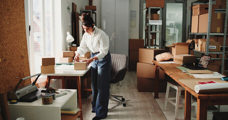 Logistics, entrepreneur or woman with box label, shipping address or packaging process for ecommerce. Customer info, parcel preparation or person with small business order, courier or mailing details