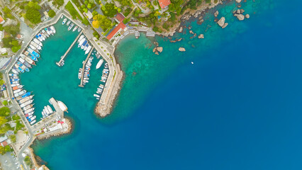 Antalya, Turkey. Top-down aerial drone view of Old Town Kaleici marina, rocky shore, Hidirlik Tower and network of streets with traditional houses.. Aerial View