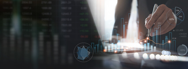 Business, finance and investment concept. Businessman using digital tablet analyzing financial data with economic graph growth chart, Business strategy and planning. market research
