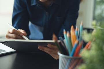 Architecture and interior design concept. Asian business woman architect using digital tablet for...