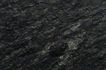 Rich in amphibole and pyroxene with less quartz giving it an ove