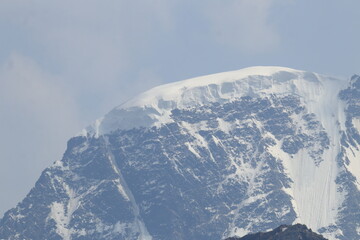A snow cap on the top of Mount Donguz Orun on a summer day