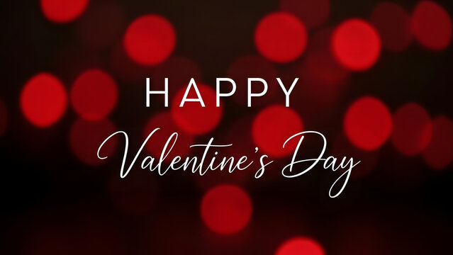 Blurred red bokeh lights and a valentine s day greeting on black background