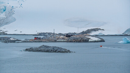 Port Lockroy Antarctica Penguin Post Office Orange Shuttle Rides Towards it. Remote British Science Station. Penguin Colony Habitat Frozen Landscape
