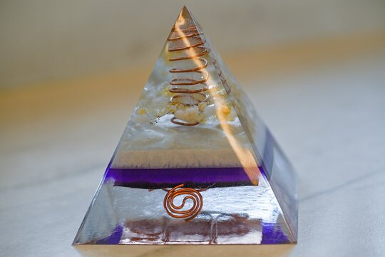 High resolution close up color image of a Purple and White Orgone Pyramid Isolated on White Background