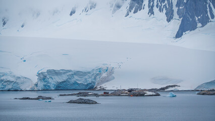Port Lockroy Antarctica Penguin Post Office. Orange Shuttle Docked Wide. Remote British Science Station. Penguin Colony Habitat Frozen Landscape