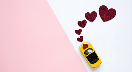 yellow toy convertible car with red glitter hearts trail on pink and white background for valentines day romantic road trip honeymoon travel or wedding anniversary celebration