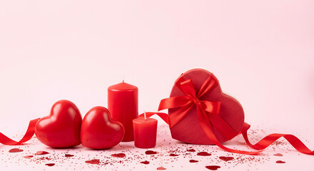 Valentine Day romantic composition with heart shaped gift box red candles and hearts on pink background with glitter and ribbon for celebration of love and anniversary holiday