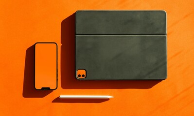 A dark green leather journal and a smartphone on an orange background with shadows