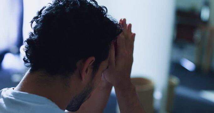 Thinking, man and stress in bedroom at house with anxiety, overthinking and insomnia reflection. Person, prayer and worry for mental health, emotional pressure and mindfulness for spiritual guidance