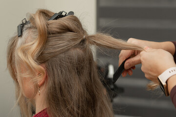 Fototapeta premium Elegant Adult Woman During Festive Evening Hairstyling in Beauty Salon