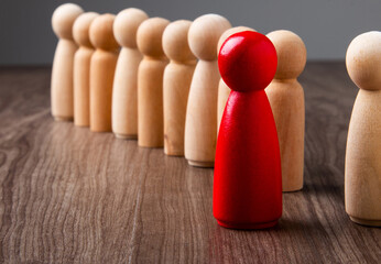 Red wooden peg leading diverse business team