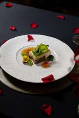 A culinary masterpiece: a beautifully presented dish with garnishes and rose petals on a plate