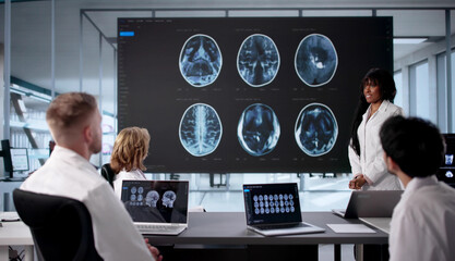 Medical Team Examines MRI Scan In Office