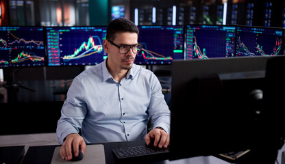 Hispanic Stock Broker Examining Online Trades