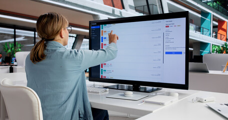 Tech-Savvy Woman Monitoring Software Support Tickets © Andrey Popov