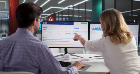 Man Using OKR Dashboard For Financial Market Analysis