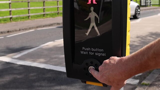 Close Up of Hand Pressing Pedestrian Crossing Button on Rural Road