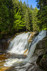 Fototapeta premium Mumlava waterfall flowing over granite rocks in Krkonose National Park