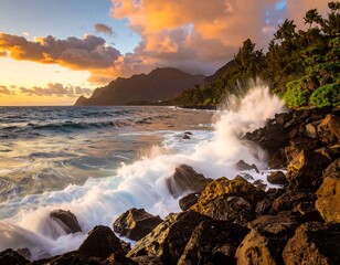Obraz premium Ocean waves crash against rocky shoreline under a vibrant sunset sky, mountains and palm trees nearby