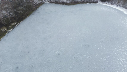 Natural frozen lake landscape with trees