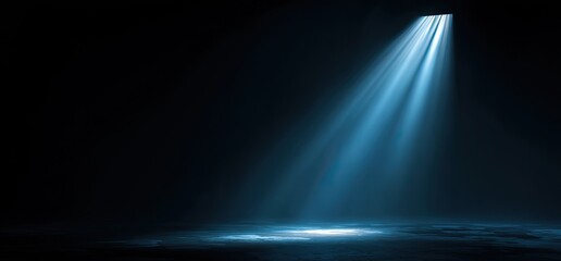 A bright beam of blue light shines from above in darkness