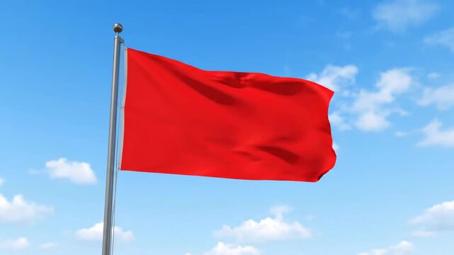 Red flag waving against blue sky symbolic of freedom and alert