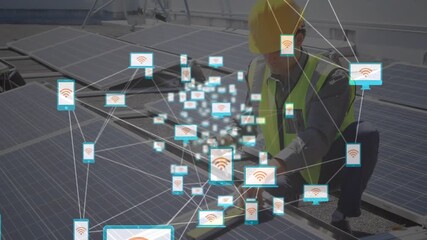 Animation of network of digital icons over male engineer setting up solar panels on the roof - Powered by Adobe